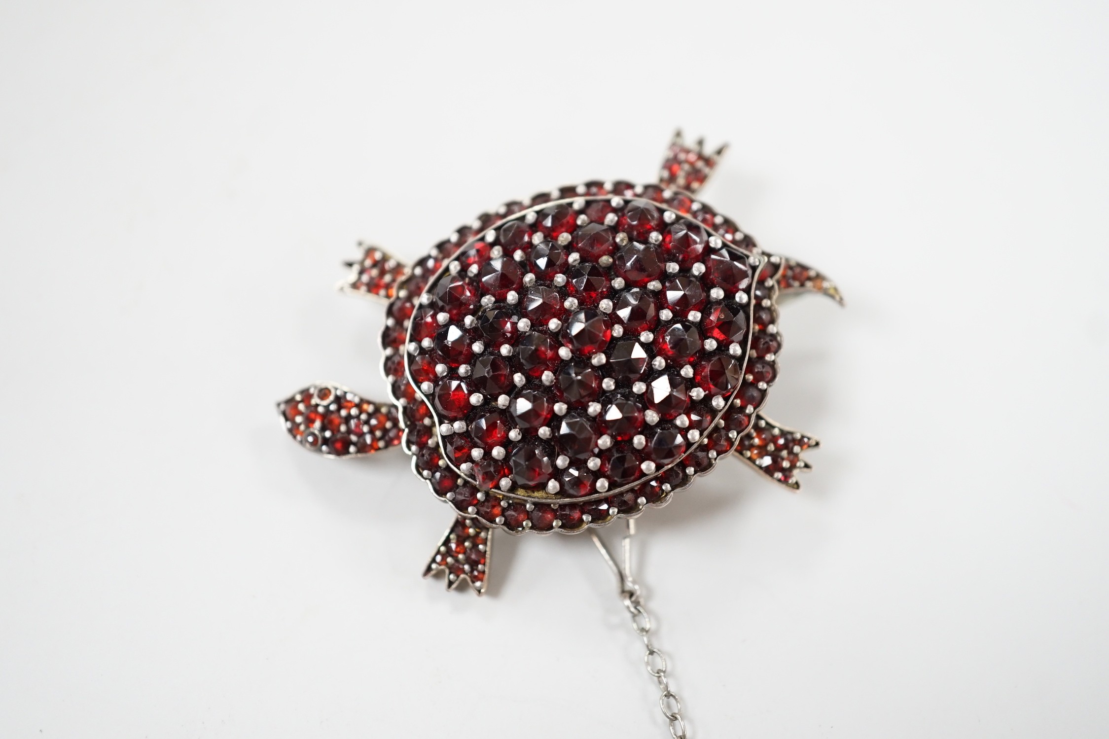 A late Victorian gold plated and pave set garnet tortoise brooch